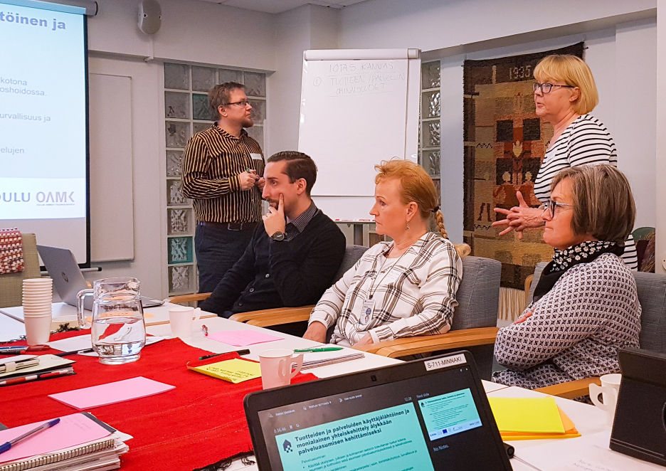 Facilitators talk to a group of people