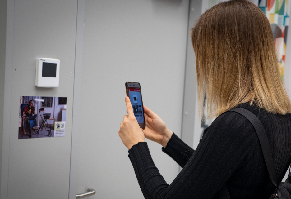 Woman points a picture with mobile phone